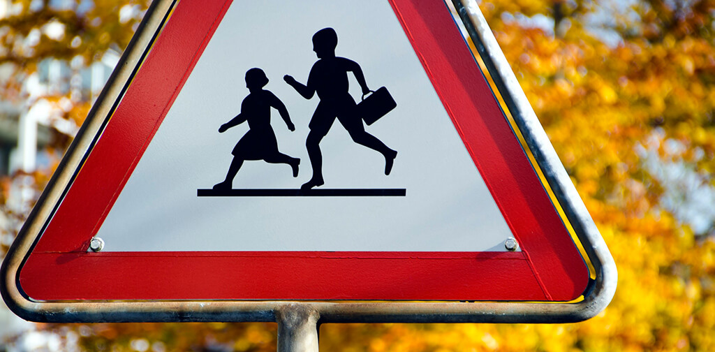 A road sign showing an outline of children at play can be quickly understood