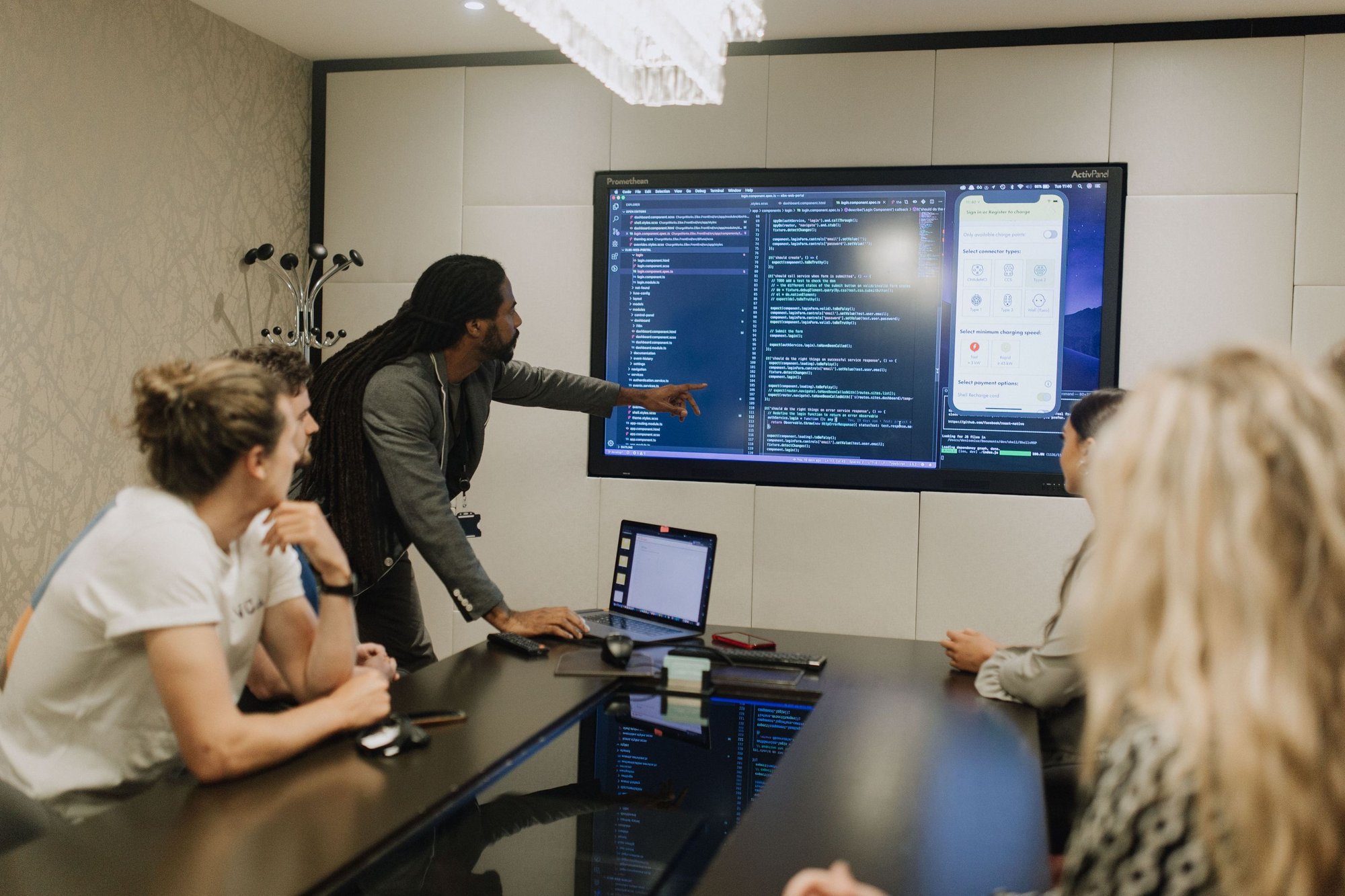 man teaching from big screen monitor