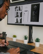 Designer working at a computer creating a UX or UI design