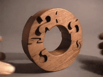A circular wooden puzzle that is designed so that the pieces never align perfectly